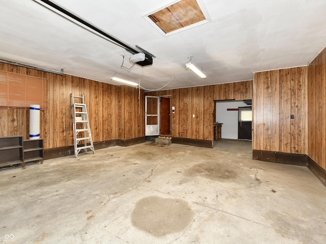 garage with wooden walls and a garage door opener