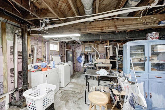 basement with water heater and washer and dryer