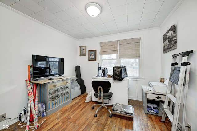 home office featuring wood-type flooring and ornamental molding