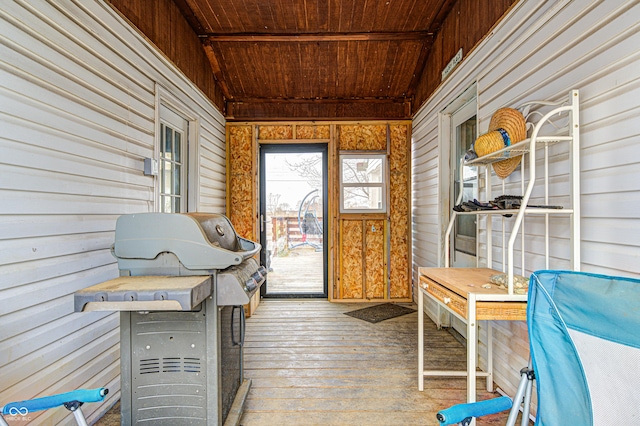 unfurnished sunroom featuring lofted ceiling and wood ceiling