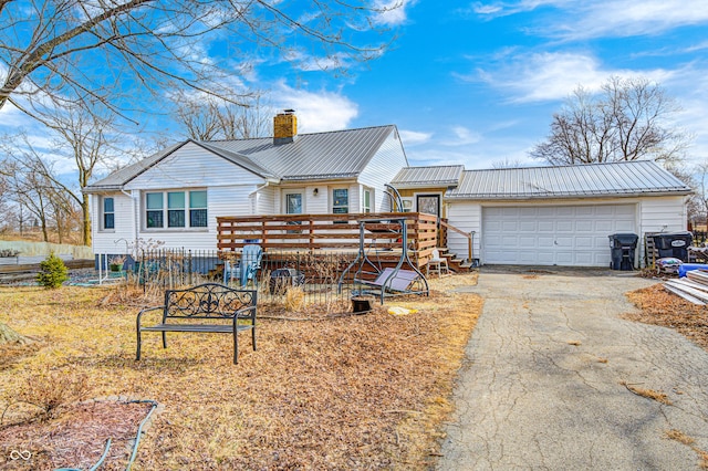 view of front of home featuring a deck, metal roof, and a chimney