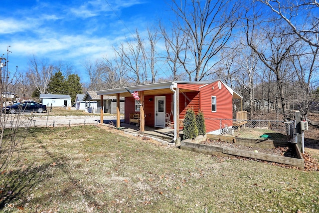 view of front of house featuring a front lawn and a vegetable garden