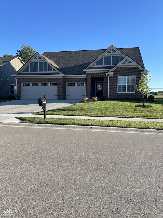 view of front of property with a front yard, brick siding, driveway, and an attached garage