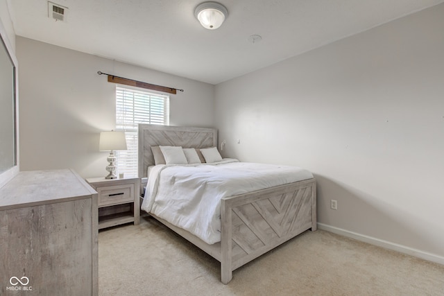 bedroom featuring light colored carpet, visible vents, and baseboards