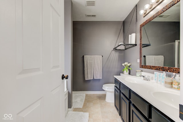 full bath with double vanity, a sink, and visible vents