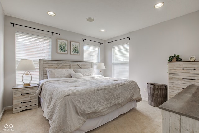 bedroom with baseboards, recessed lighting, and light colored carpet