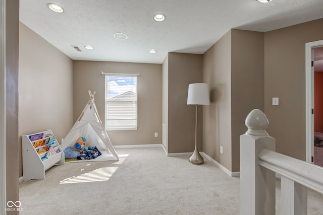 rec room featuring visible vents, baseboards, carpet, a textured ceiling, and recessed lighting