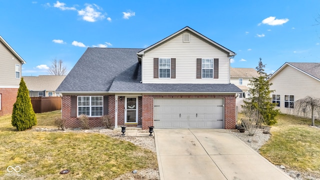 traditional-style home featuring a garage, concrete driveway, fence, a front lawn, and brick siding