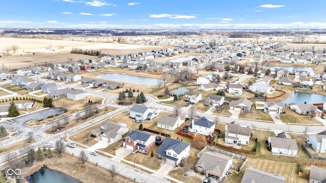 drone / aerial view with a residential view and a water view