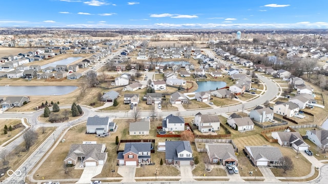 drone / aerial view featuring a water view and a residential view