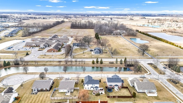 drone / aerial view featuring a water view and a residential view