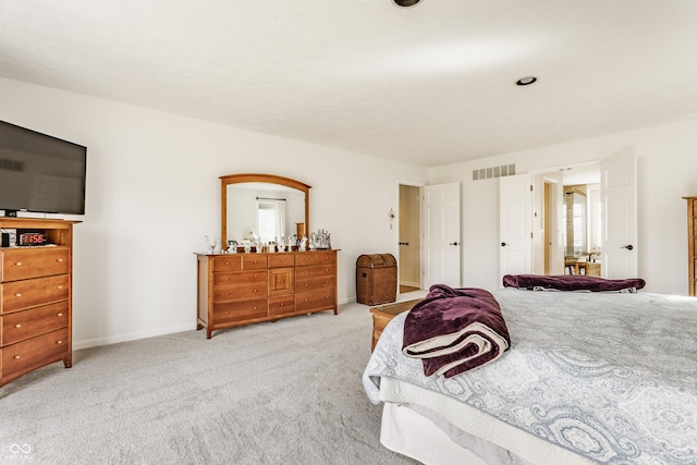 carpeted bedroom with visible vents and baseboards