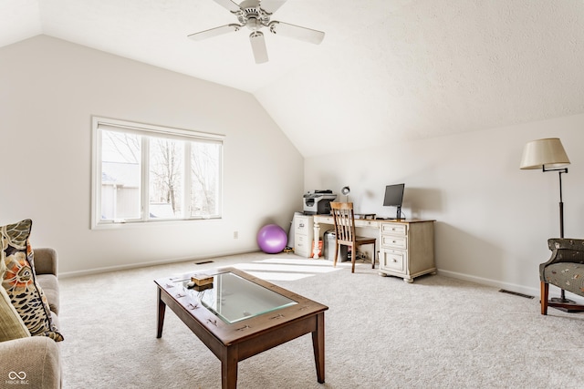 carpeted living area with visible vents, lofted ceiling, baseboards, and ceiling fan