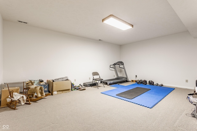 workout area featuring visible vents and carpet