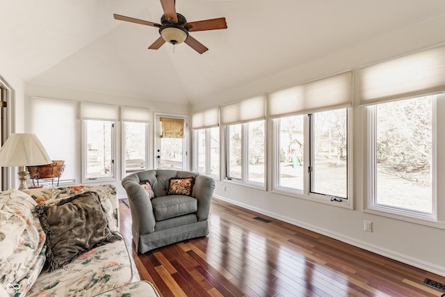 sunroom with vaulted ceiling, a ceiling fan, and visible vents