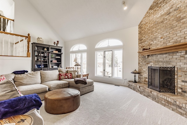 carpeted living area with visible vents, a brick fireplace, and high vaulted ceiling