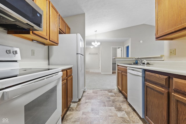 kitchen featuring a chandelier, white appliances, a sink, vaulted ceiling, and light countertops