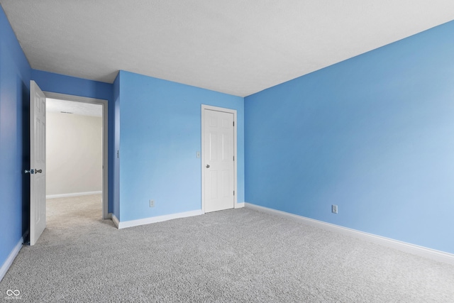 unfurnished bedroom with carpet and baseboards