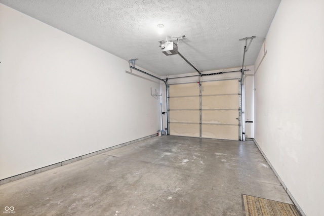 garage with a garage door opener and baseboards