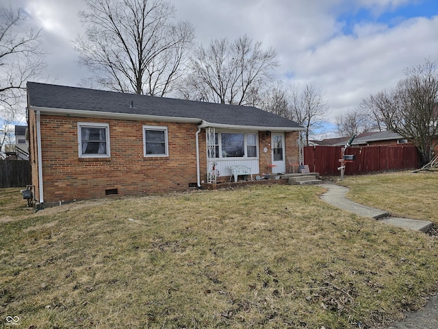 ranch-style house featuring crawl space, brick siding, fence, and a front lawn