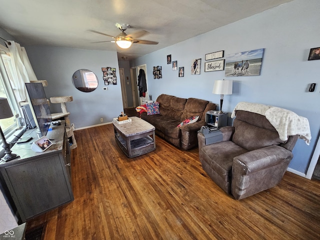 living room featuring baseboards, a ceiling fan, and wood finished floors