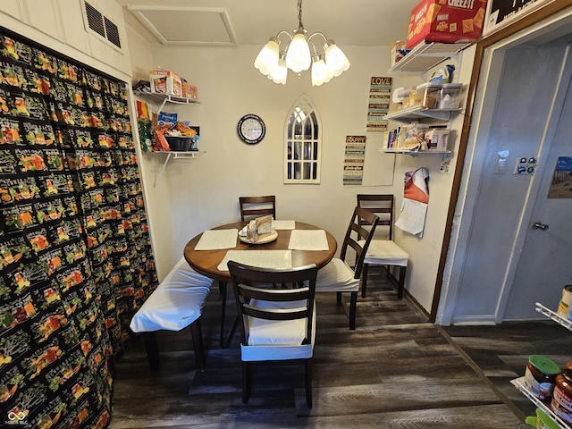 dining room with dark wood-style floors, a chandelier, visible vents, and baseboards