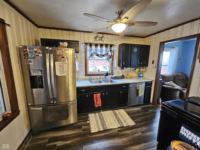 kitchen with stainless steel appliances, a healthy amount of sunlight, light countertops, and a sink