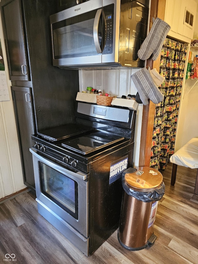 kitchen featuring visible vents, appliances with stainless steel finishes, and wood finished floors