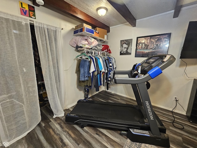 workout room with wood finished floors and baseboards