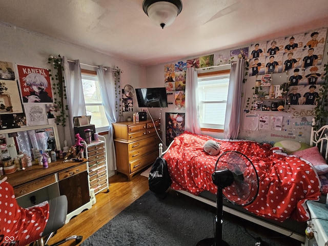 bedroom with wood finished floors