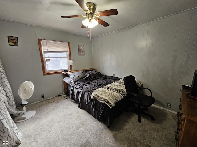 bedroom with a ceiling fan and carpet