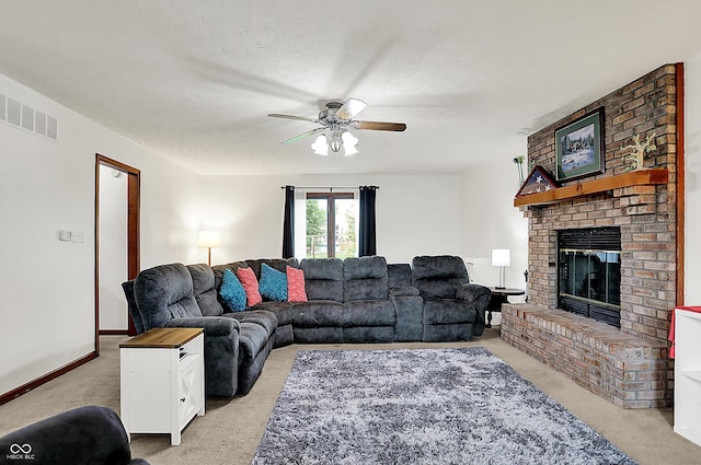 211 Deborah Ln, Whiteland, IN 46184 - living area featuring light colored carpet, a ceiling fan, a fireplace, and a textured ceiling