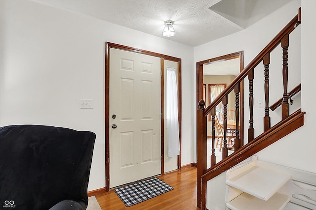 211 Deborah Ln, Whiteland, IN 46184 - entrance foyer with light wood-style floors, a textured ceiling, stairs, and baseboards