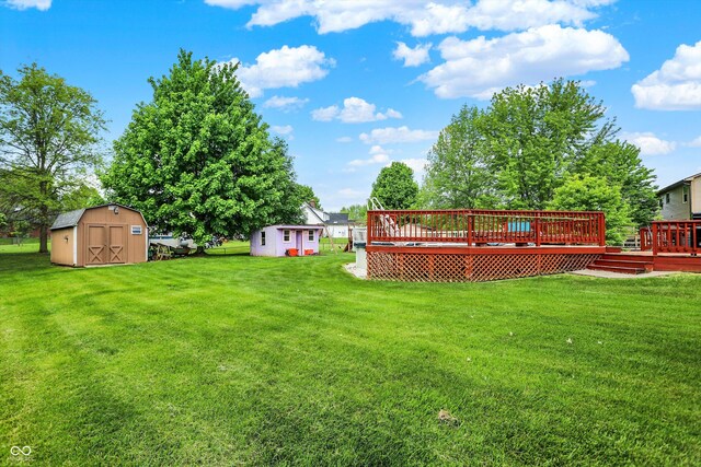 211 Deborah Ln, Whiteland, IN 46184 - view of grassy yard featuring a shed, an outdoor structure, and a wooden deck