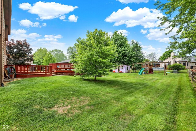 211 Deborah Ln, Whiteland, IN 46184 - view of yard featuring a playground, a wooden deck, an outdoor structure, and a storage shed