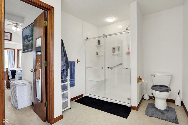 211 Deborah Ln, Whiteland, IN 46184 - bathroom featuring a shower stall, baseboards, ceiling fan, and toilet