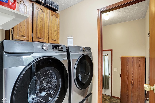 211 Deborah Ln, Whiteland, IN 46184 - clothes washing area with washing machine and dryer, a textured ceiling, cabinet space, stone finish flooring, and baseboards