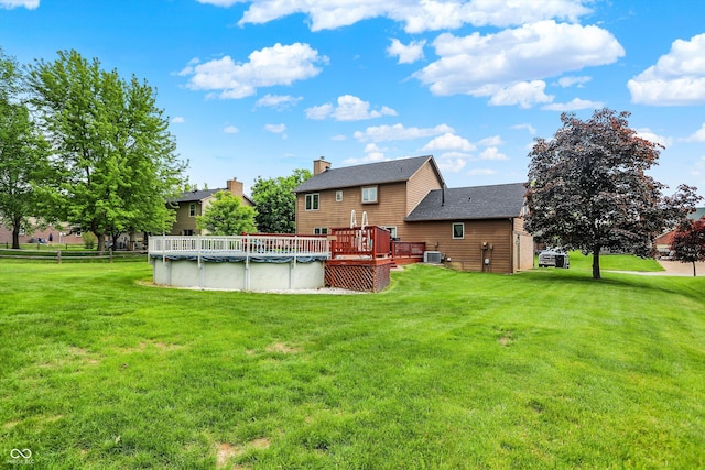 211 Deborah Ln, Whiteland, IN 46184 - back of property with a deck, a yard, a covered pool, and cooling unit
