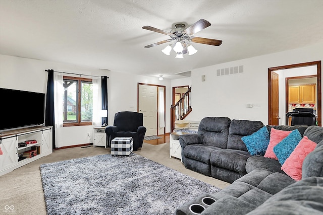 211 Deborah Ln, Whiteland, IN 46184 - living area with light colored carpet, stairs, and a ceiling fan