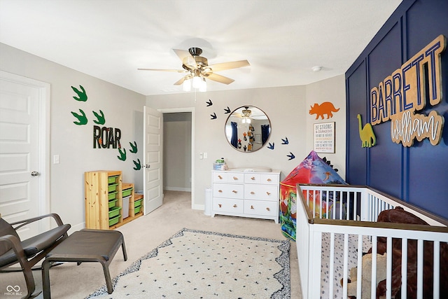 bedroom featuring light carpet, ceiling fan, and baseboards