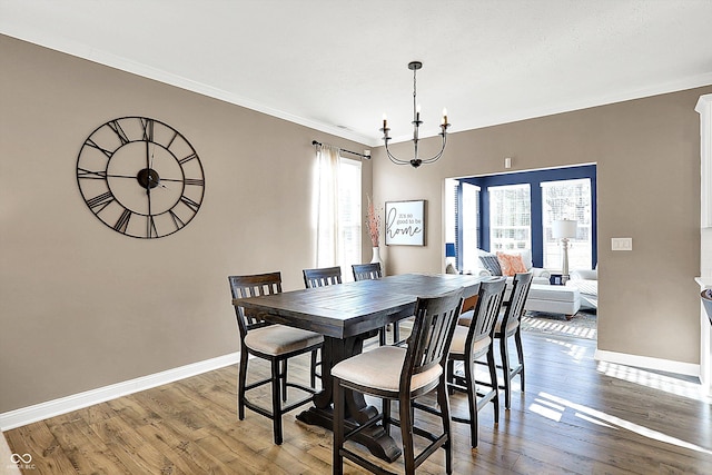 dining area with baseboards, a healthy amount of sunlight, and hardwood / wood-style floors