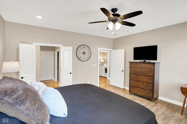 bedroom with light wood-style floors, baseboards, washer / clothes dryer, and ceiling fan