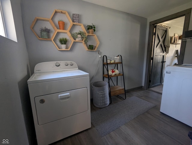 laundry room with laundry area, washer and clothes dryer, and wood finished floors