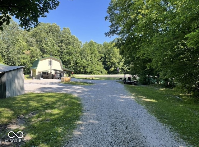 view of street with gravel driveway