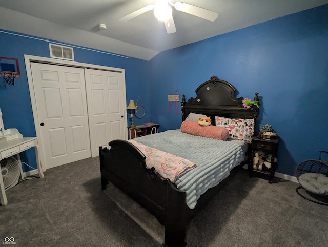 bedroom featuring vaulted ceiling, visible vents, dark carpet, and a closet