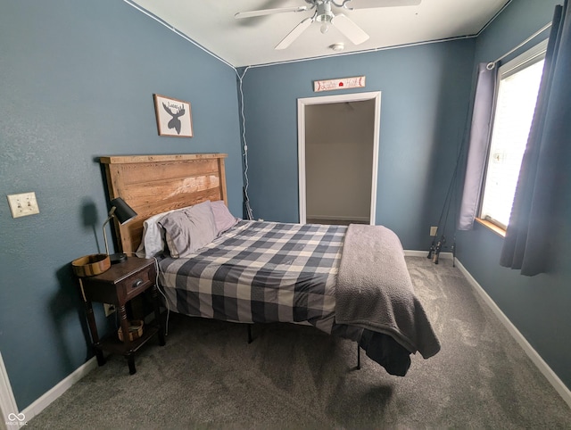 bedroom with a ceiling fan, baseboards, and carpet flooring