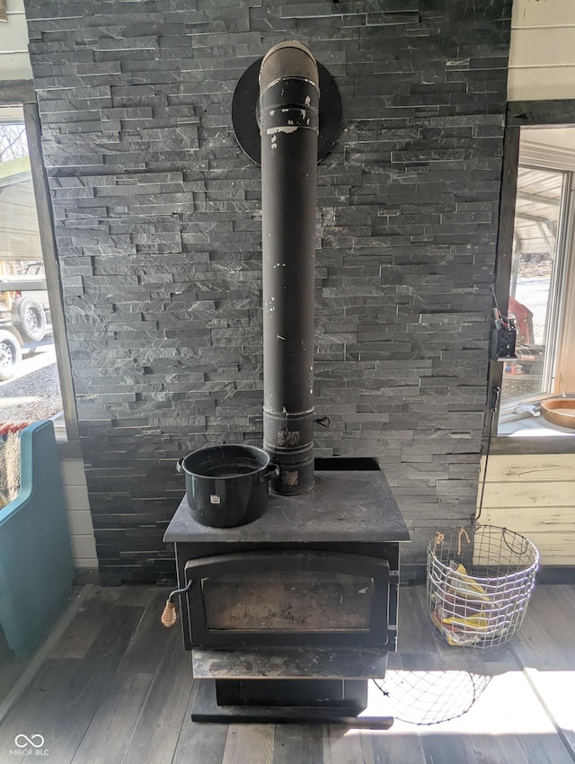 room details with a wood stove and wood finished floors