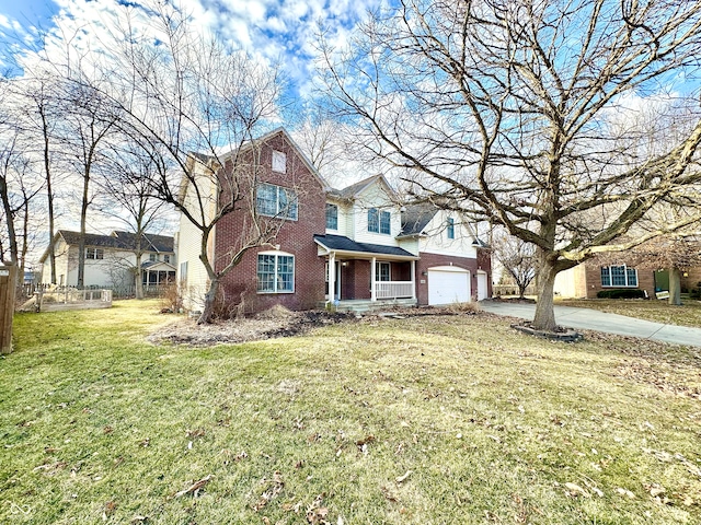 traditional-style home with driveway, a garage, a front yard, and brick siding