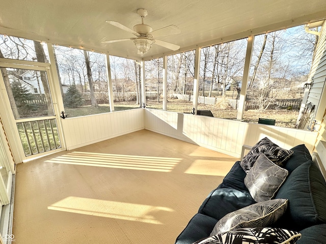 unfurnished sunroom featuring a ceiling fan