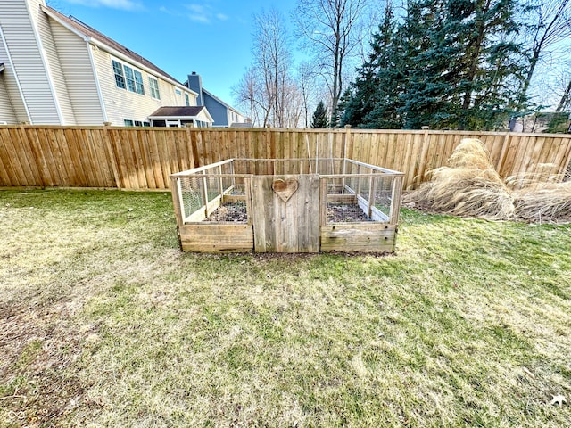 view of yard featuring fence and a vegetable garden